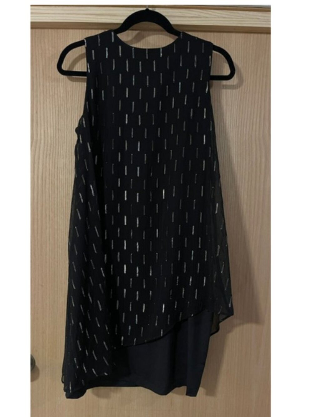 SLNY black sleeveless layered top featuring an asymmetrical hem